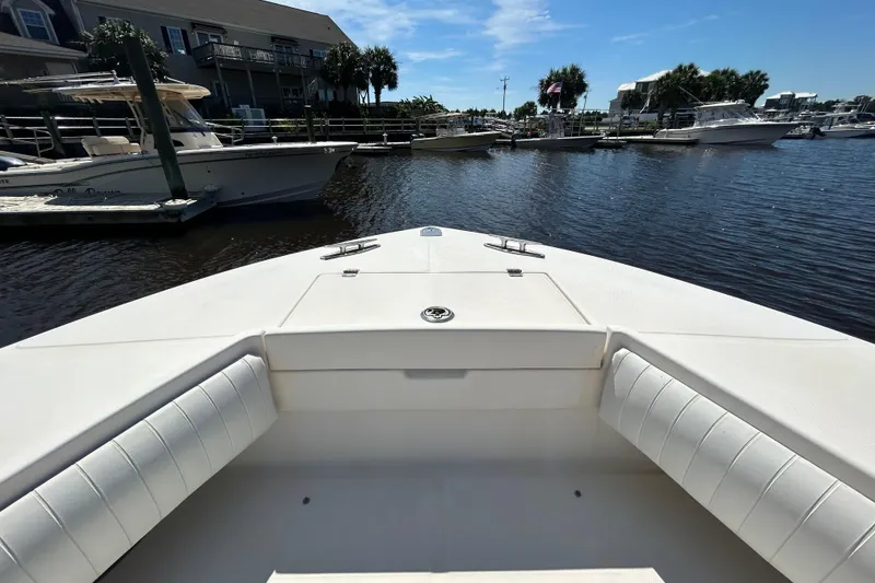 Slide: The Image of 2005 Regulator 26 Forward Seating boat docked in a sunny marina. - 33