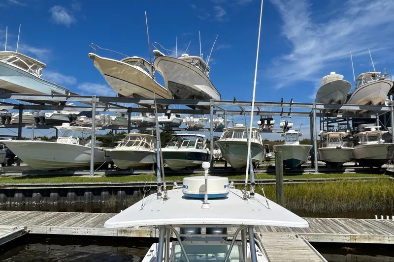Slide: The Image of Boats stored on racks at a marina under a clear blue sky. - 37