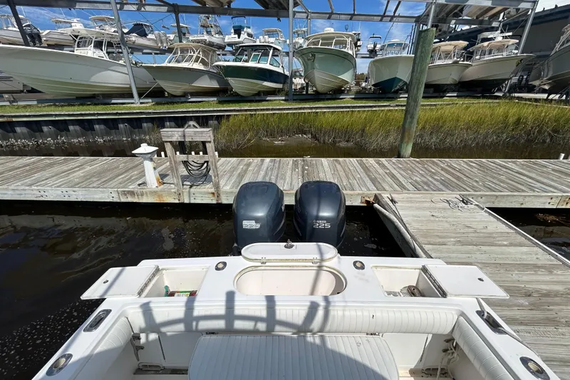 Slide: The Image of 2005 Regulator 26 Forward Seating boat docked with twin Yamaha 225 engines. - 5