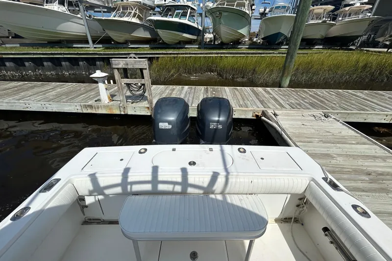 Slide: The Image of 2005 Regulator 26 Forward Seating boat docked with twin Yamaha 225 engines. - 6