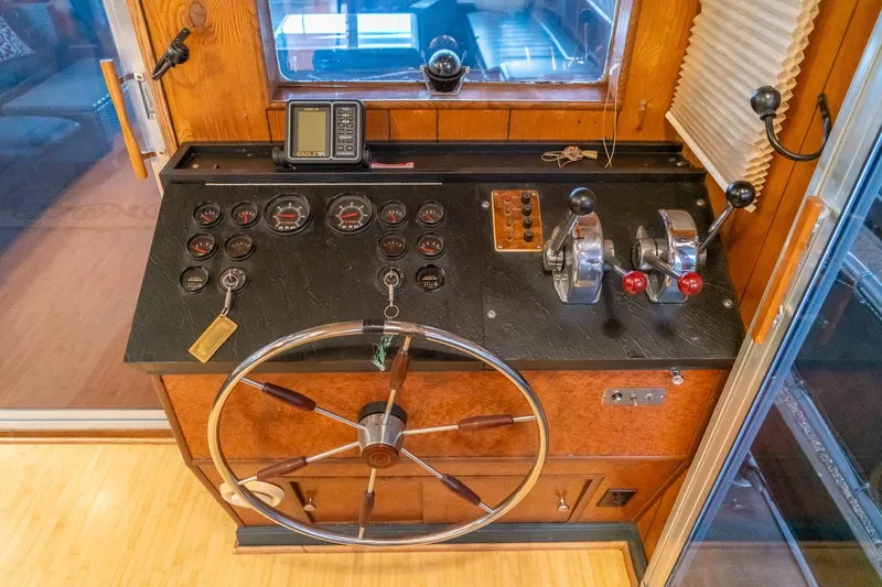 Slide: The Image of 1984 Sumerset 60 X 14 houseboat helm with steering wheel and control panel. - 14