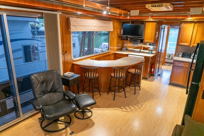 Slide: The Image of Interior of 1984 Sumerset 60 X 14 houseboat with cozy seating and kitchen area. - 20