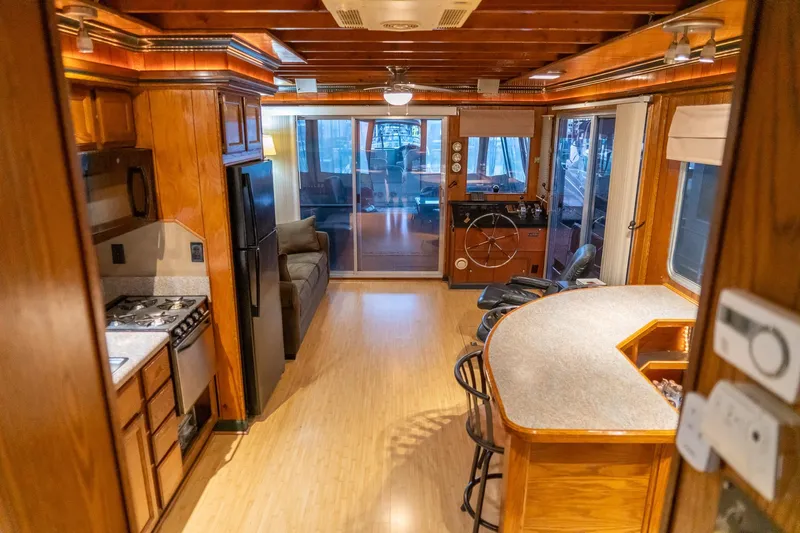 Slide: The Image of Interior of a 1984 Sumerset 60 X 14 houseboat with wooden decor and modern amenities. - 26
