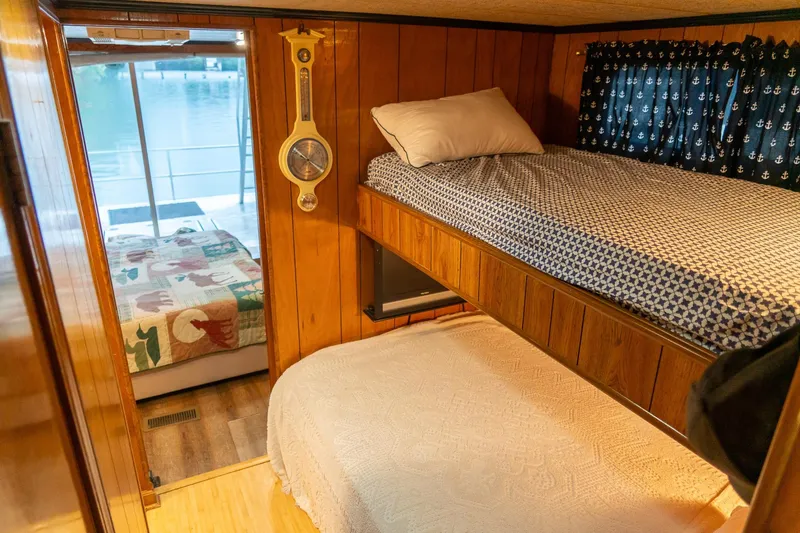 Slide: The Image of Cozy 1984 Sumerset 60 X 14 houseboat interior with bunk beds and lake view. - 27