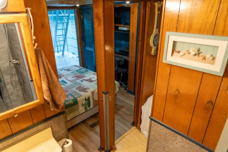 Slide: The Image of 1984 Sumerset 60 X 14 houseboat interior with wood paneling and cozy bedroom. - 32