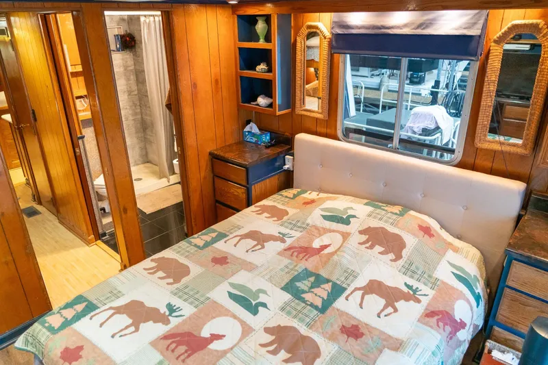 Slide: The Image of Cozy bedroom in 1984 Sumerset 60 X 14 houseboat with rustic decor and wood paneling. - 36
