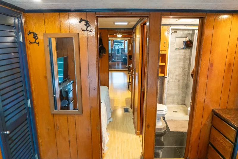 Slide: The Image of Interior of a 1984 Sumerset 60 X 14 houseboat with wood paneling and bathroom. - 38