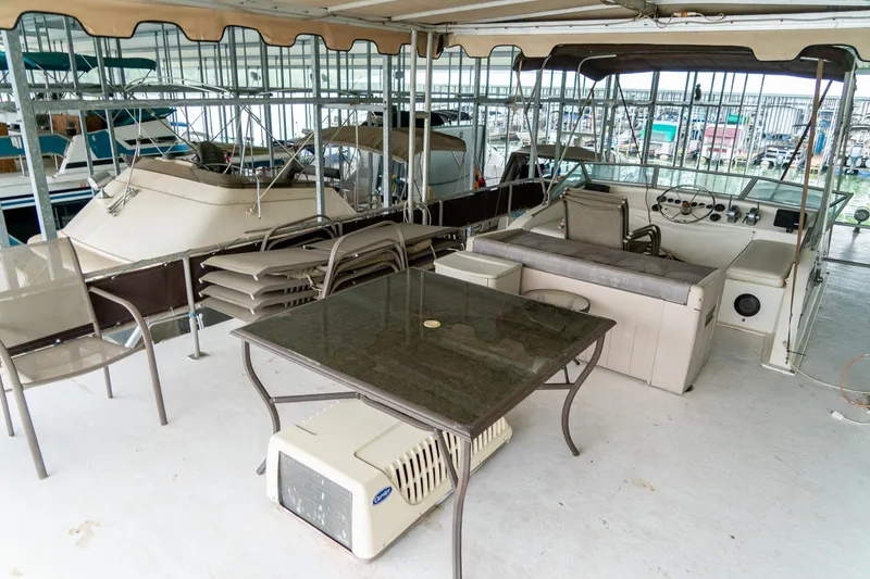Slide: The Image of 1984 Sumerset 60 X 14 houseboat deck with seating, table, and helm station. - 45