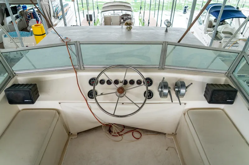 Slide: The Image of 1984 Sumerset 60 X 14 Houseboat helm with steering wheel and controls. - 46