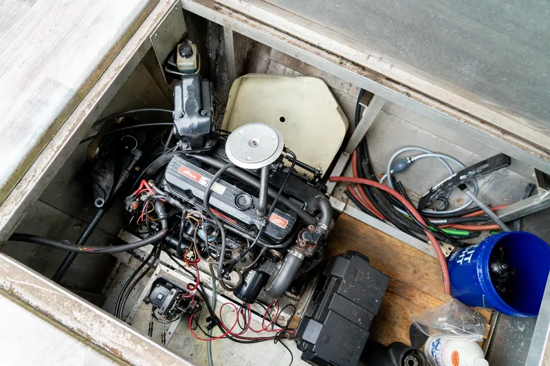 Slide: The Image of Engine compartment of a 1984 Sumerset 60 X 14 houseboat, showing detailed wiring and components. - 48