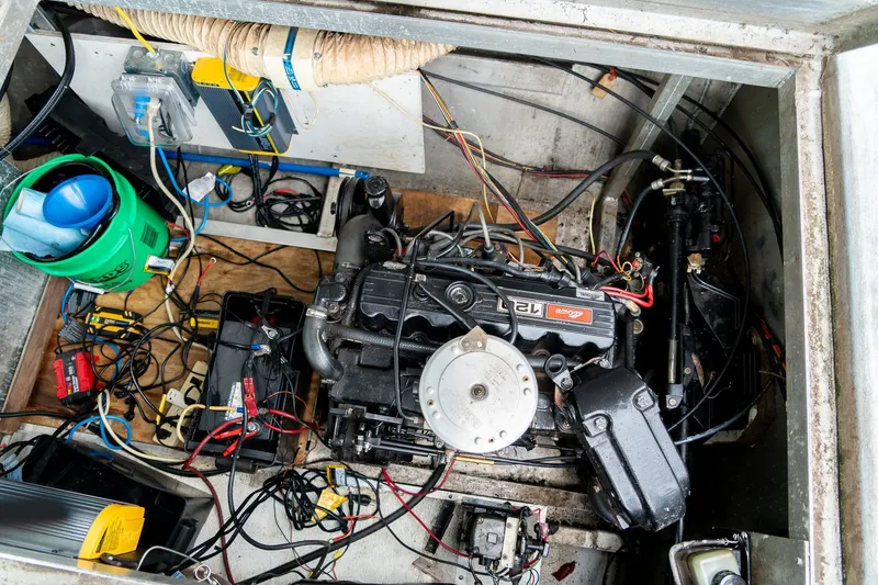 Slide: The Image of Engine compartment of a 1984 Sumerset 60 X 14 houseboat, showing wiring and components. - 49
