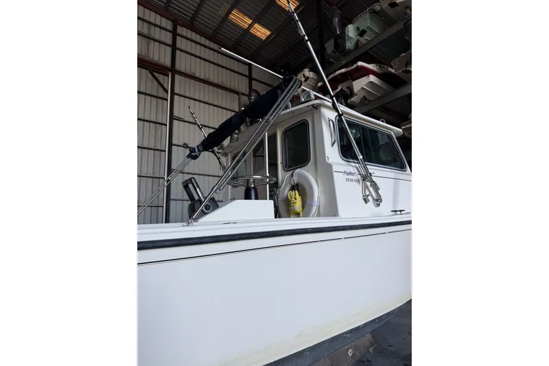 Slide: The Image of 2006 Parker 2820 XL Sport Cabin boat in storage, side view. - 1