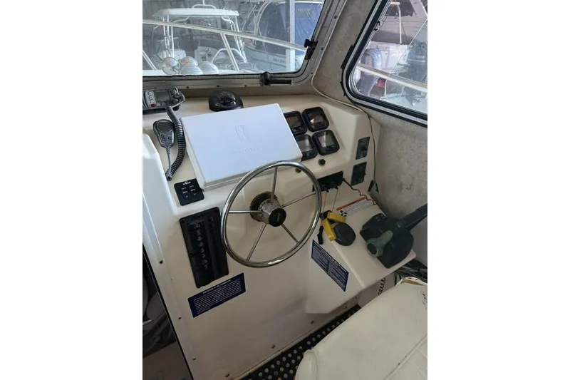 Slide: The Image of 2006 Parker 2820 XL Sport Cabin helm with steering wheel and control panel. - 9