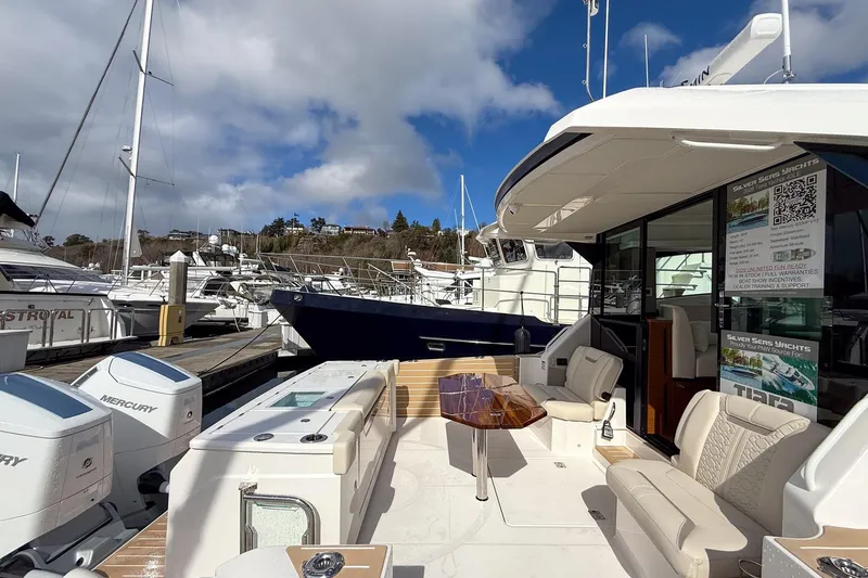 Slide: The Image of Luxurious 2026 Tiara Yachts 43 LE docked, showcasing elegant seating and Mercury engines. - 12