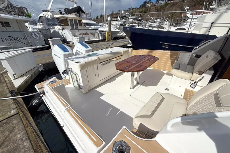 Slide: The Image of 2026 Tiara Yachts 43 LE luxury boat interior with seating and table at marina. - 14