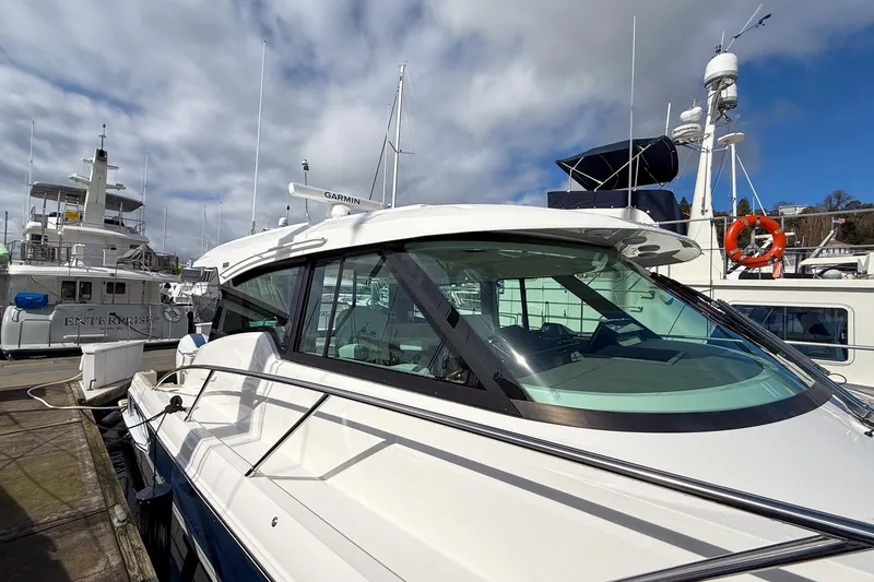 Slide: The Image of 2026 Tiara Yachts 43 LE docked at marina under cloudy sky. - 15