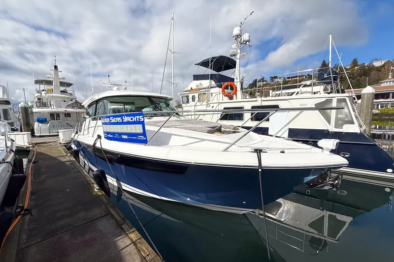 Slide: The Image of 2026 Tiara Yachts 43 LE docked at marina under cloudy sky. - 16