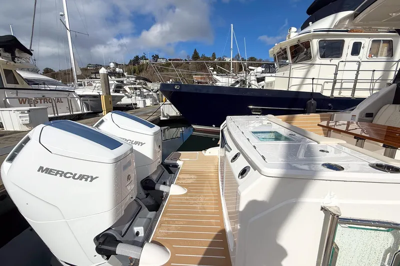Slide: The Image of 2026 Tiara Yachts 43 LE with dual Mercury engines docked at marina. - 17