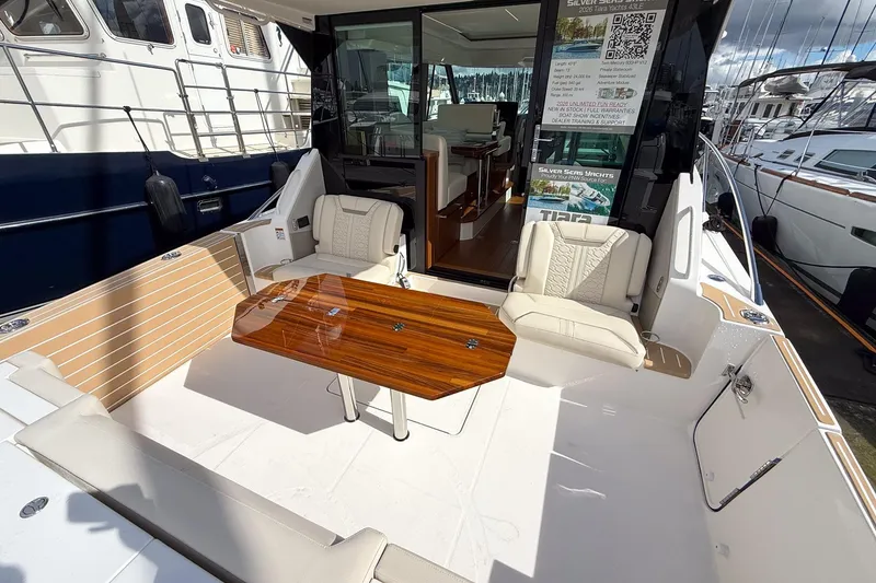 Slide: The Image of Luxurious 2026 Tiara Yachts 43 LE with elegant seating and polished wood table. - 18