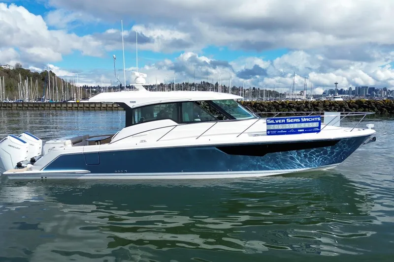 Slide: The Image of 2026 Tiara Yachts 43 LE in marina, showcasing sleek design and modern features. - 2