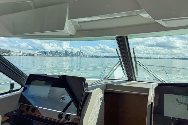 Slide: The Image of Interior view from 2026 Tiara Yachts 43 LE, overlooking calm waters and city skyline. - 20