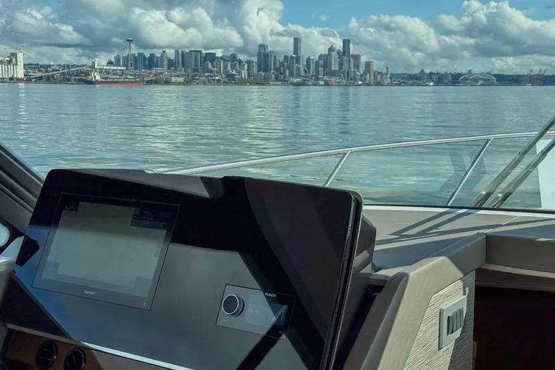 Slide: The Image of 2026 Tiara Yachts 43 LE dashboard with city skyline view in the background. - 21