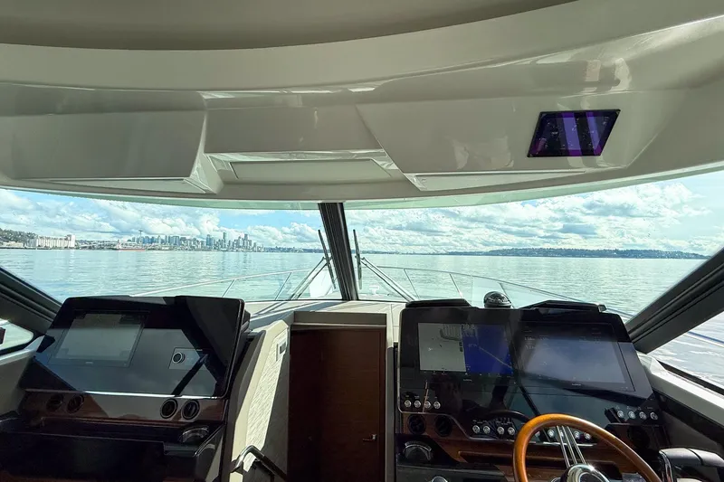 Slide: The Image of Interior view of 2026 Tiara Yachts 43 LE helm with city skyline in background. - 22