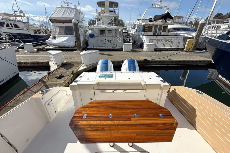 Slide: The Image of 2026 Tiara Yachts 43 LE at marina, featuring sleek deck and luxurious wood finish. - 24