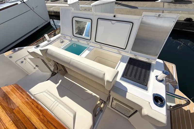 Slide: The Image of 2026 Tiara Yachts 43 LE cockpit with seating, storage, and grill on deck. - 26