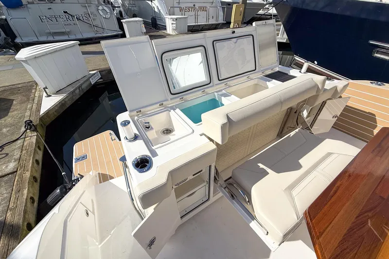 Slide: The Image of 2026 Tiara Yachts 43 LE interior with seating and storage at a marina. - 29