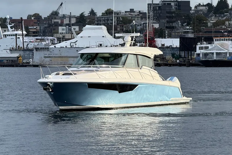 The Image of 2026 Tiara Yachts 43 LE cruising in a harbor with urban backdrop. - 0