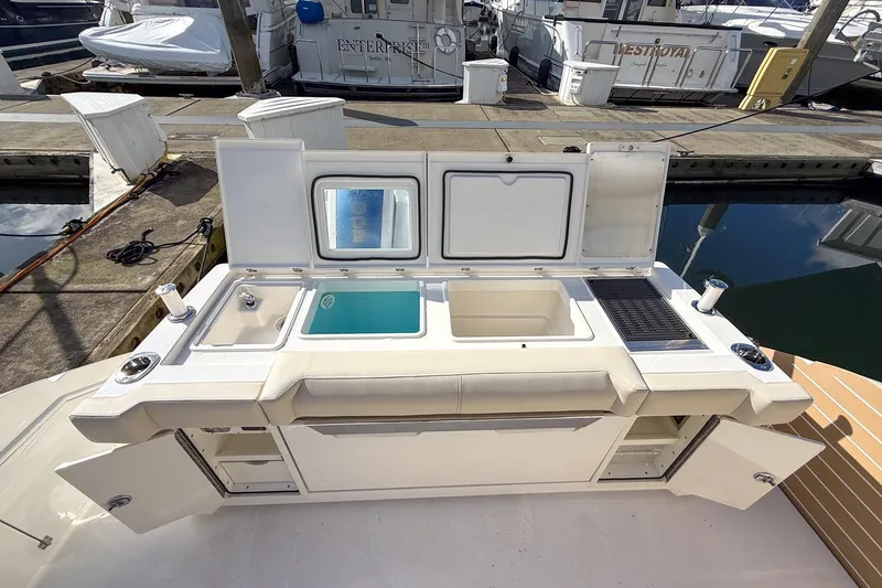 Slide: The Image of Outdoor kitchen on 2026 Tiara Yachts 43 LE, featuring sink, grill, and storage. - 31