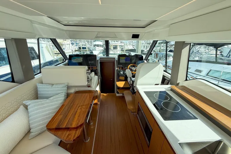 Slide: The Image of 2026 Tiara Yachts 43 LE interior with modern helm, seating, and kitchen area. - 35