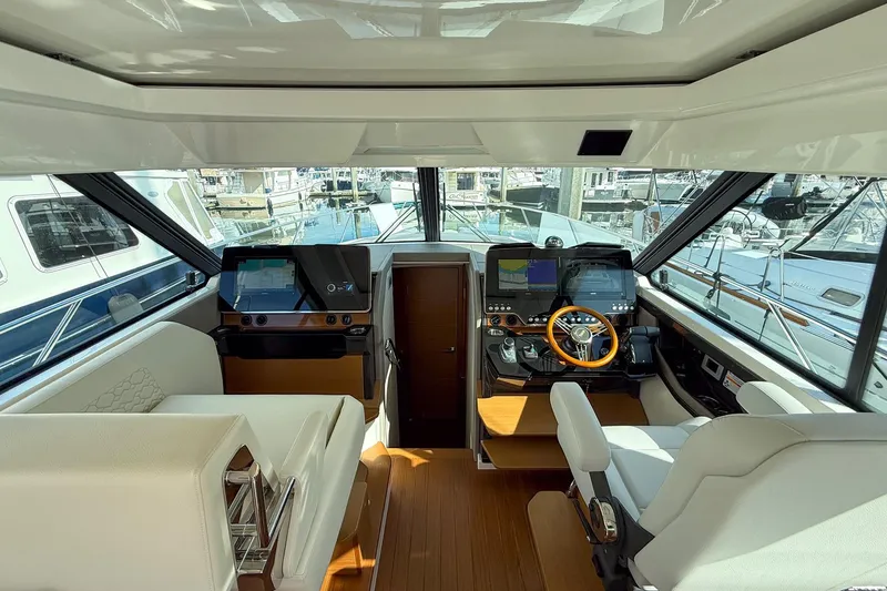 Slide: The Image of Interior of 2026 Tiara Yachts 43 LE, featuring modern helm and navigation systems. - 36