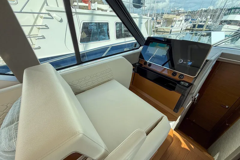 Slide: The Image of Interior helm of 2026 Tiara Yachts 43 LE with modern navigation display. - 37