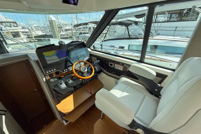Slide: The Image of Helm of 2026 Tiara Yachts 43 LE with modern controls and luxurious seating. - 38