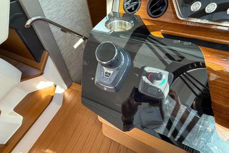 Slide: The Image of Control panel of 2026 Tiara Yachts 43 LE with joystick and throttle controls. - 45