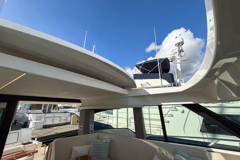 Slide: The Image of 2026 Tiara Yachts 43 LE interior with open roof, docked under blue sky. - 47