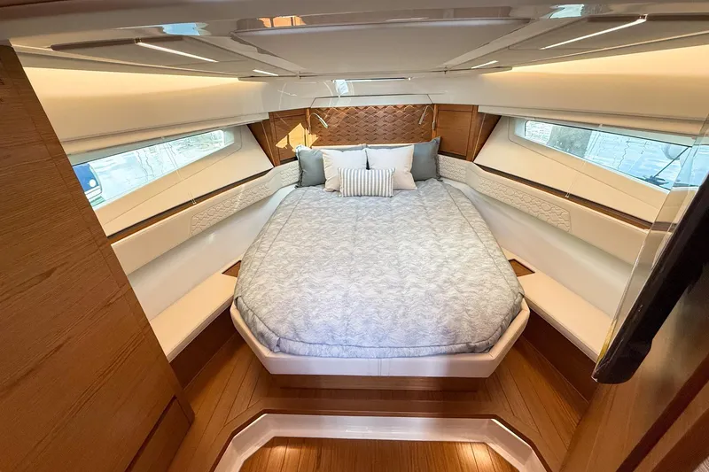 Slide: The Image of Luxurious cabin interior of 2026 Tiara Yachts 43 LE with elegant bedding and wood accents. - 48