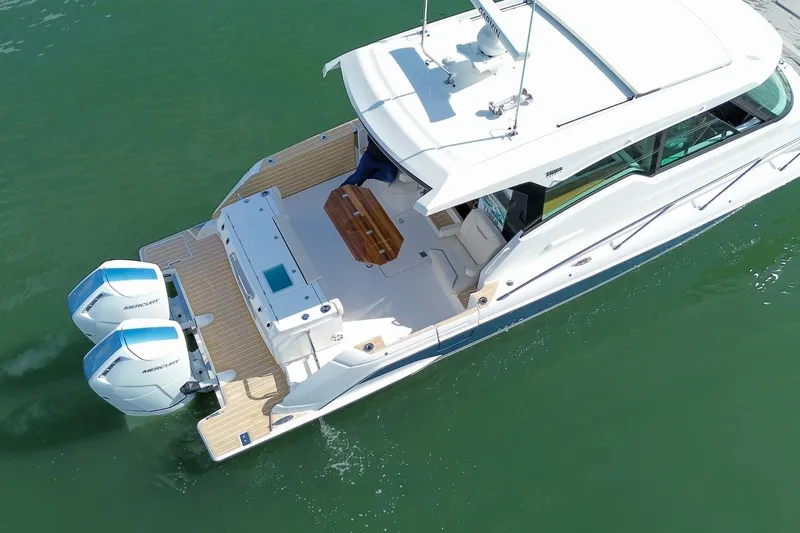 Slide: The Image of 2026 Tiara Yachts 43 LE with dual outboard engines on calm water. - 5