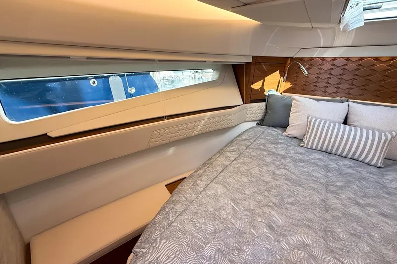 Slide: The Image of Luxurious interior of 2026 Tiara Yachts 43 LE, featuring elegant bedding and modern design. - 50
