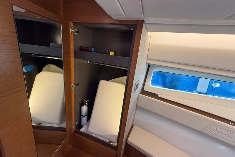 Slide: The Image of Interior of 2026 Tiara Yachts 43 LE, featuring a wooden cabinet and window view. - 51