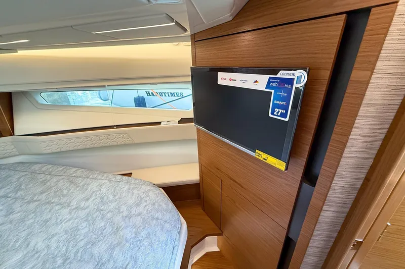 Slide: The Image of Interior of 2026 Tiara Yachts 43 LE with modern TV and cozy bed. - 53