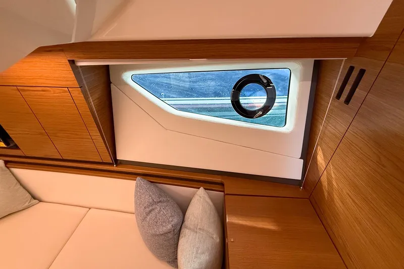 Slide: The Image of Interior cabin view of 2026 Tiara Yachts 43 LE, featuring modern wood paneling and window. - 59