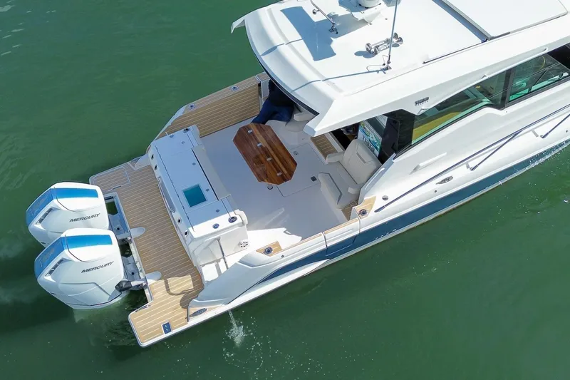 Slide: The Image of 2026 Tiara Yachts 43 LE cruising on water, featuring dual Mercury engines. - 6