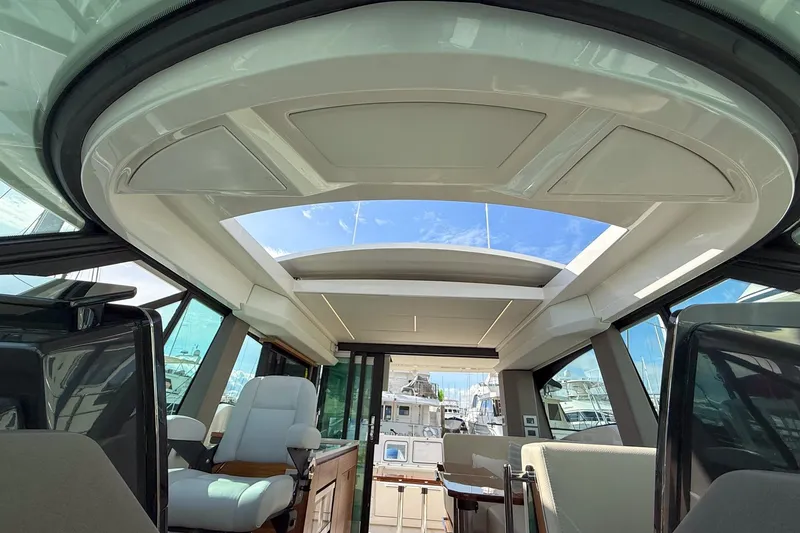 Slide: The Image of Interior view of 2026 Tiara Yachts 43 LE, featuring luxurious seating and panoramic windows. - 60