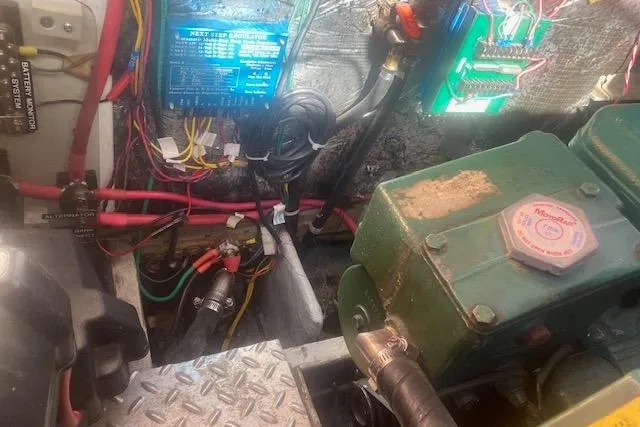 Slide: The Image of Engine room of a 1985 Baba 40 Pilot House with wiring and machinery. - 26