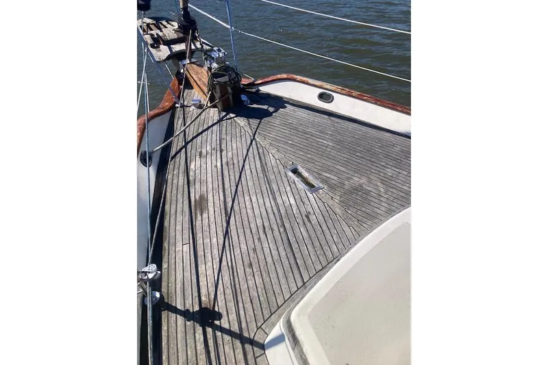Slide: The Image of Deck of 1985 Baba 40 Pilot House sailboat with wooden finish and ocean view. - 28