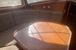 Slide: The Image of 1985 Baba 40 Pilot House interior with wooden steering wheel and controls. - 3