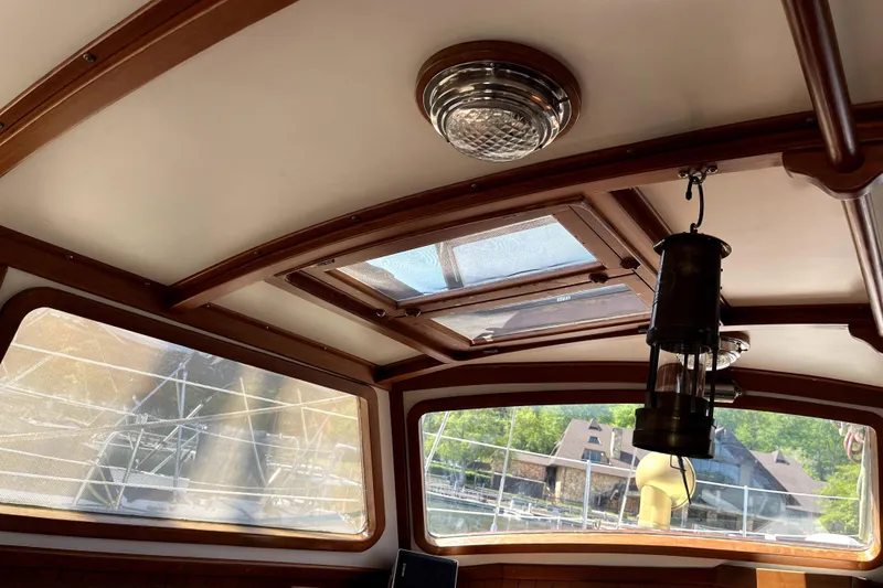 Slide: The Image of Interior view of 1985 Baba 40 Pilot House with wooden trim and skylight. - 32